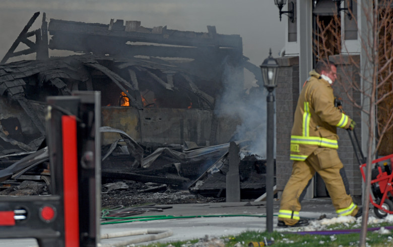 FIRESTONE, CO - APRIL 17: Flames burn inside a car as fireman takes in a fan to the house next door. Federick-Firestone FD respond to a report of a house explosion on Twilight Ave on April 17, 2017 in Firestone. There was a report of on person taken to the hospital. (Photo by John Leyba/The Denver Post via Getty Images)